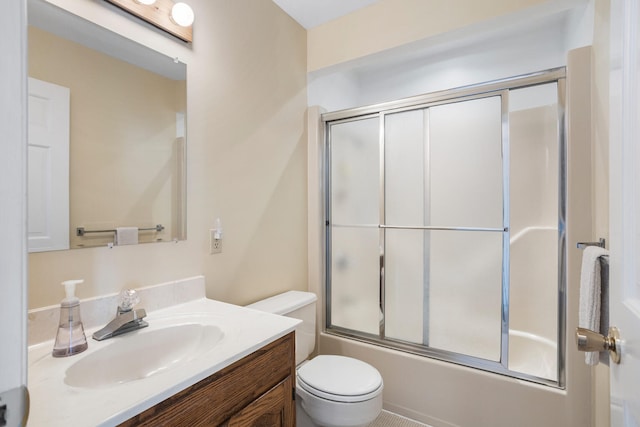 full bath with vanity, enclosed tub / shower combo, and toilet