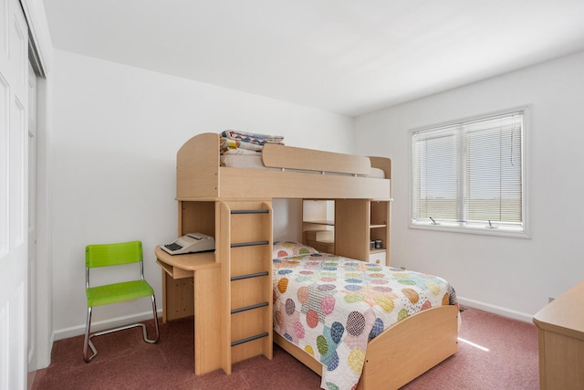 carpeted bedroom with baseboards and a closet