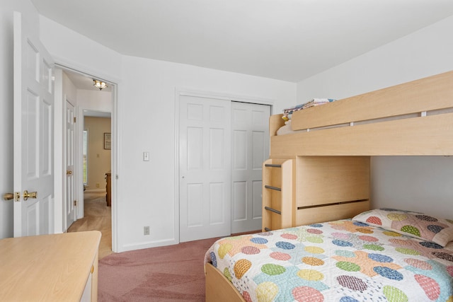 bedroom with carpet flooring, baseboards, and a closet