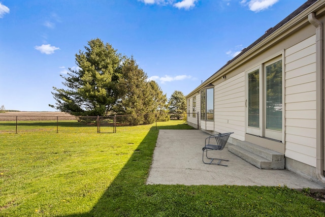 view of yard featuring fence and a patio