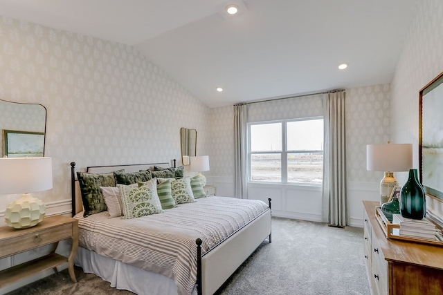 bedroom featuring wallpapered walls, light colored carpet, and lofted ceiling