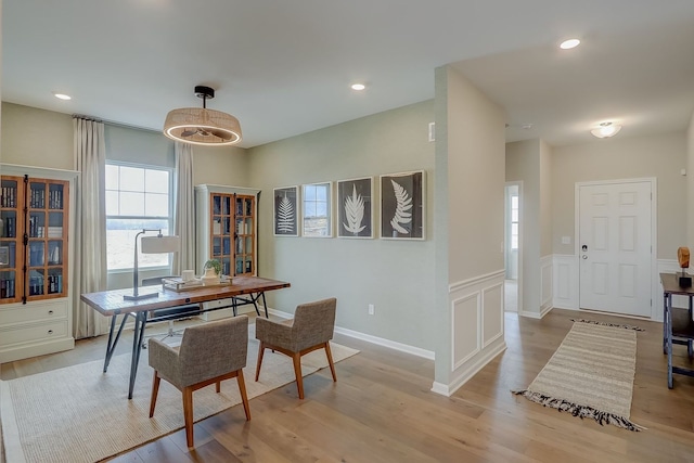 home office with a decorative wall, light wood-style flooring, recessed lighting, and wainscoting
