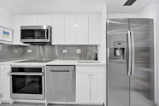 175 E Delaware Pl Unit 5803, Chicago, IL 60611 - kitchen with modern cabinets, light countertops, white cabinetry, a sink, and stainless steel appliances