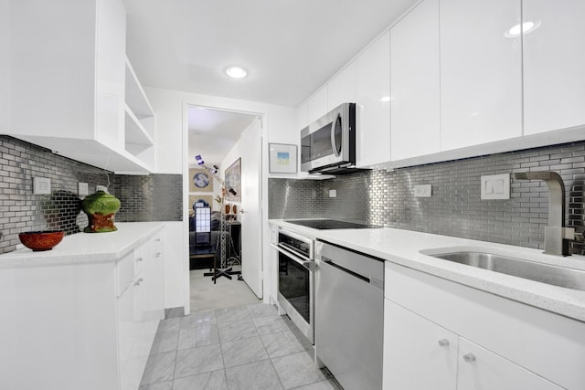 175 E Delaware Pl Unit 5803, Chicago, IL 60611 - kitchen with decorative backsplash, appliances with stainless steel finishes, open shelves, a sink, and white cabinetry