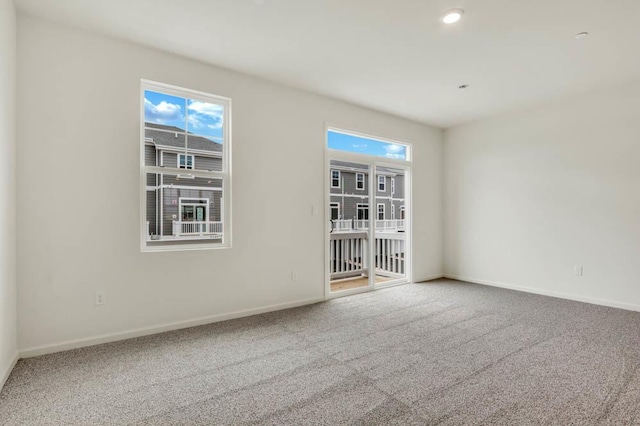 carpeted empty room with recessed lighting and baseboards