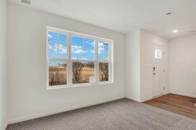 foyer featuring carpet flooring, baseboards, and recessed lighting