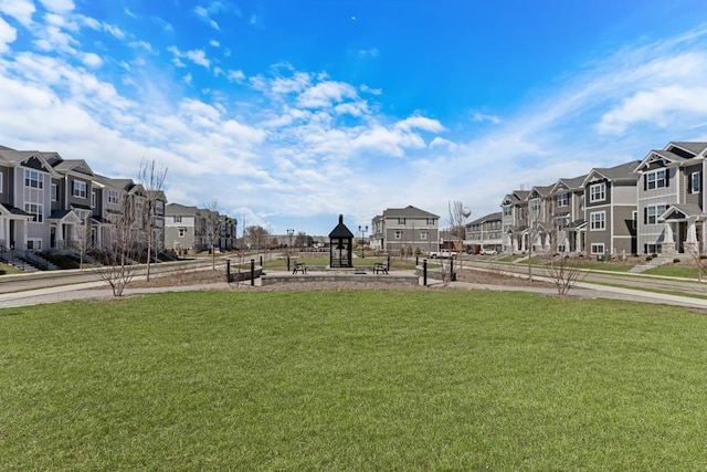 view of home's community with a residential view and a lawn