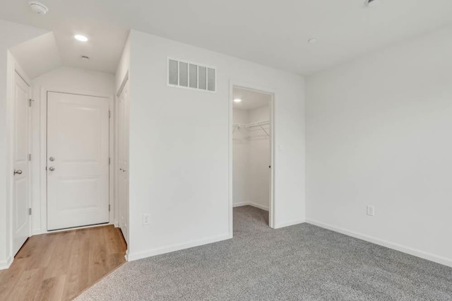 unfurnished bedroom with visible vents, a closet, baseboards, a spacious closet, and recessed lighting