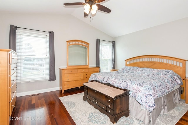 bedroom with baseboards, a ceiling fan, visible vents, lofted ceiling, and wood finished floors