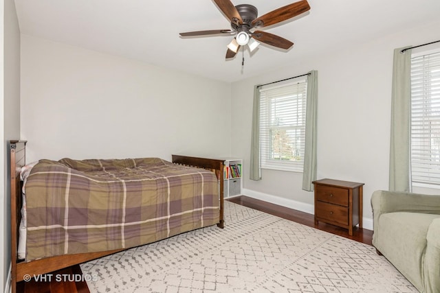 bedroom with wood finished floors, ceiling fan, and baseboards