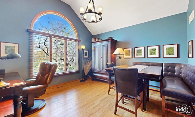 interior space featuring wood finished floors, high vaulted ceiling, and a notable chandelier