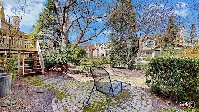 view of yard featuring stairway, central AC unit, a residential view, a patio area, and a wooden deck