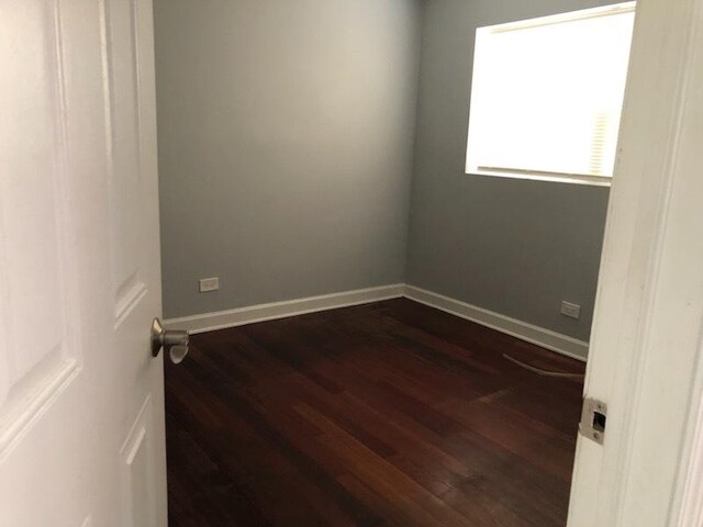 1937 W Pratt Ave Unit 1N, Chicago, IL 60626 - unfurnished room featuring dark wood-style flooring and baseboards
