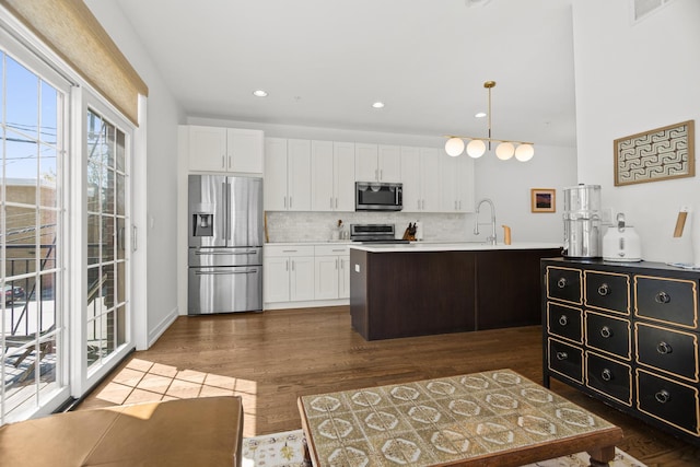 1020 Cedar Ct, Oak Park, IL 60302 - kitchen with dark wood-style flooring, backsplash, white cabinets, and appliances with stainless steel finishes