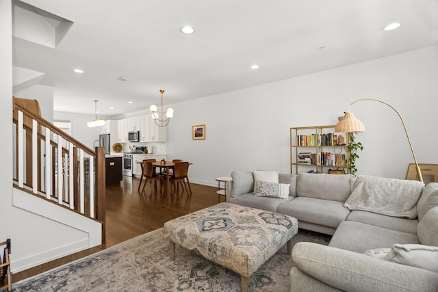 1020 Cedar Ct, Oak Park, IL 60302 - living room featuring dark wood-style flooring, stairs, an inviting chandelier, and recessed lighting