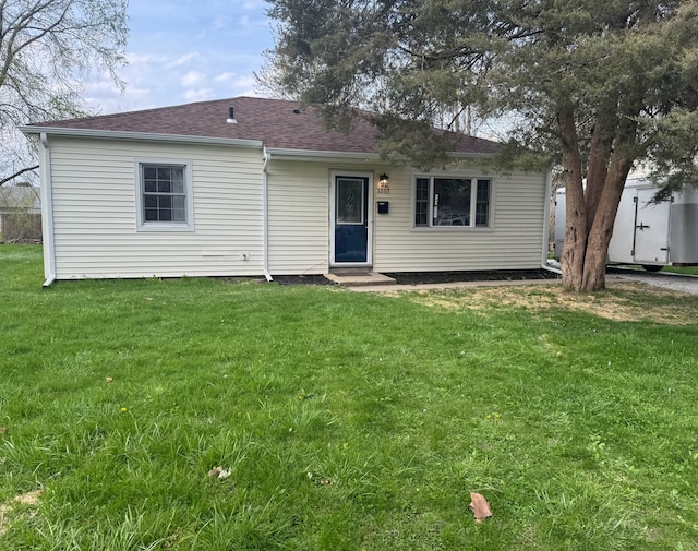 1057 Eastview Dr, Rantoul, IL 61866 - back of property featuring a yard, a shingled roof, and entry steps