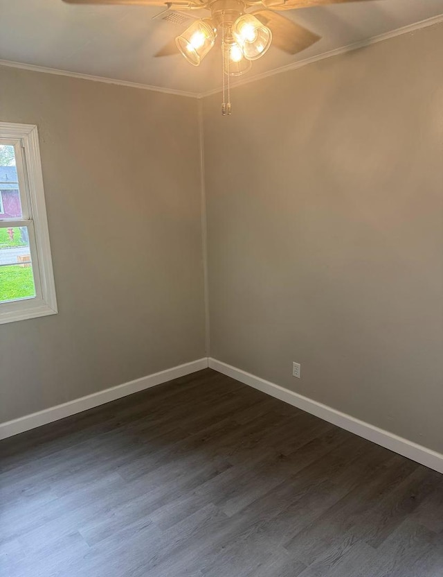 unfurnished room featuring baseboards, ornamental molding, a ceiling fan, and dark wood-style floors
