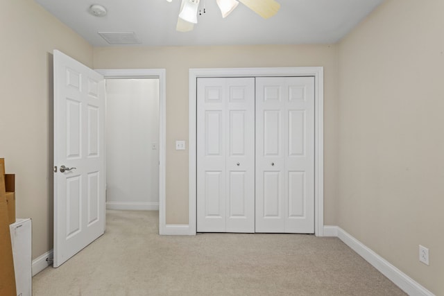 1318 Ridge Pointe Dr, Monticello, IL 61856 - unfurnished bedroom featuring ceiling fan, a closet, baseboards, and light carpet
