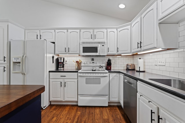 1318 Ridge Pointe Dr, Monticello, IL 61856 - kitchen with white appliances, backsplash, lofted ceiling, white cabinetry, and dark wood-type flooring