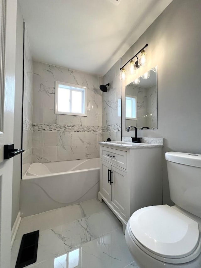 full bath with washtub / shower combination, toilet, marble finish floor, and vanity