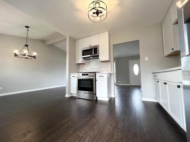 kitchen with light countertops, a chandelier, dark wood finished floors, stainless steel appliances, and backsplash