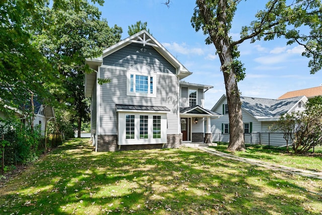 2015 N Woodlawn Park Ave, Mchenry, IL 60051 - back of property with a yard, a standing seam roof, fence, and metal roof