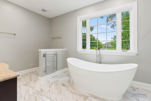 2015 N Woodlawn Park Ave, Mchenry, IL 60051 - bathroom with a freestanding tub, marble finish floor, baseboards, and vanity