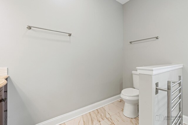 2015 N Woodlawn Park Ave, Mchenry, IL 60051 - half bathroom featuring toilet, marble finish floor, vanity, and baseboards
