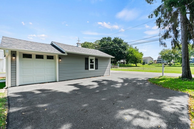 2015 N Woodlawn Park Ave, Mchenry, IL 60051 - view of property exterior with aphalt driveway, an attached garage, a lawn, and roof with shingles