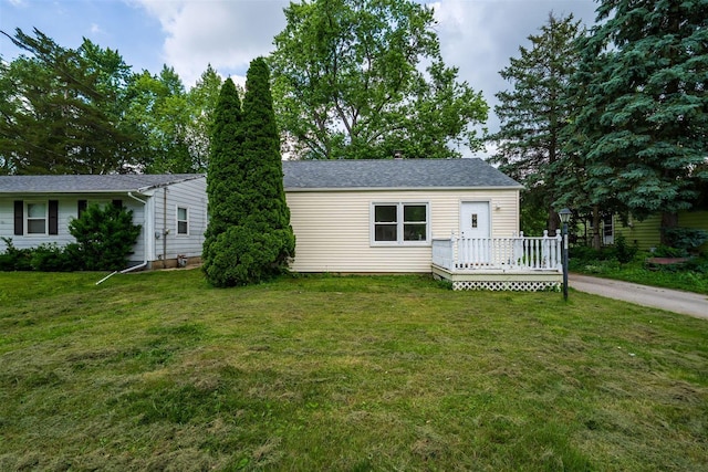 212 Keiser Ave, Normal, IL 61761 - view of front of house featuring a deck, a front lawn, and roof with shingles