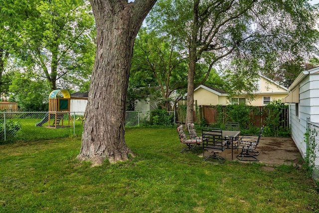212 Keiser Ave, Normal, IL 61761 - fenced backyard featuring a playground and a patio