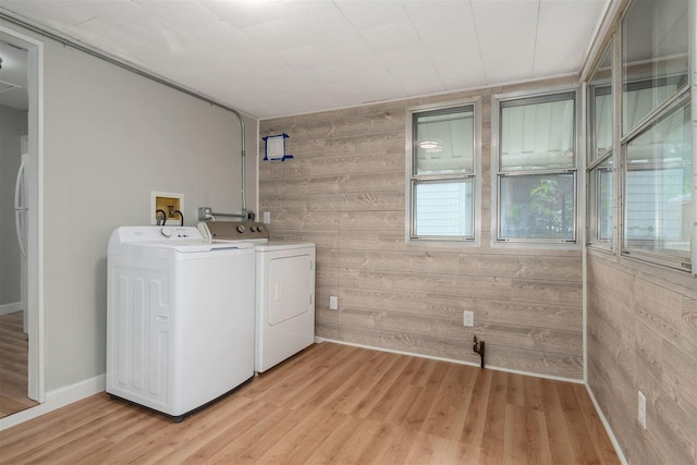 212 Keiser Ave, Normal, IL 61761 - washroom featuring separate washer and dryer, wooden walls, and light wood-style flooring