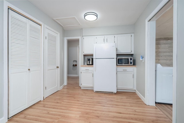 212 Keiser Ave, Normal, IL 61761 - kitchen with freestanding refrigerator, stainless steel microwave, light wood-type flooring, and white cabinetry