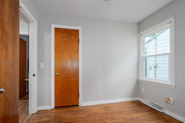 212 Keiser Ave, Normal, IL 61761 - unfurnished bedroom featuring wood finished floors and baseboards
