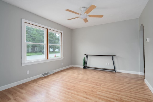 212 Keiser Ave, Normal, IL 61761 - spare room with light wood-style floors, arched walkways, and ceiling fan