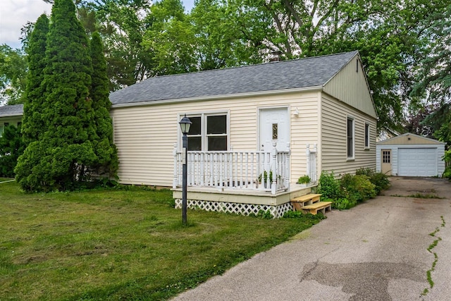 212 Keiser Ave, Normal, IL 61761 - view of front of property featuring an outdoor structure, driveway, a shingled roof, a detached garage, and a wooden deck
