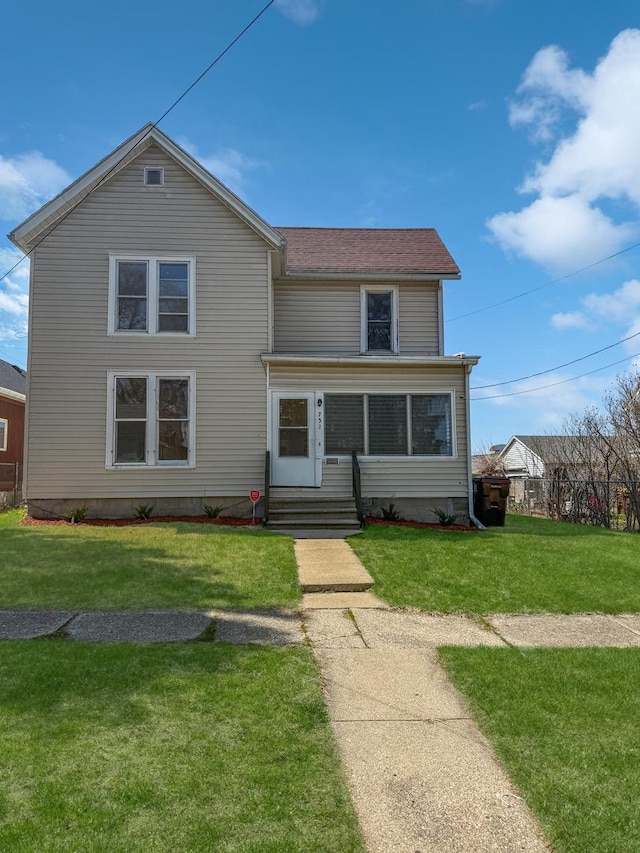 732 S 14th Ave, Freeport, IL 61032 - traditional-style home featuring a front yard and entry steps
