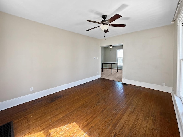 732 S 14th Ave, Freeport, IL 61032 - empty room featuring dark wood-style flooring, baseboards, a ceiling fan, and visible vents