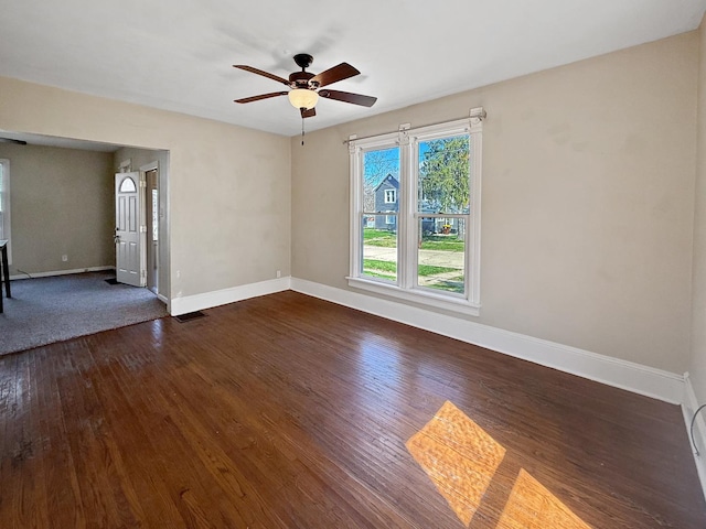 732 S 14th Ave, Freeport, IL 61032 - empty room with ceiling fan, baseboards, visible vents, and dark wood finished floors