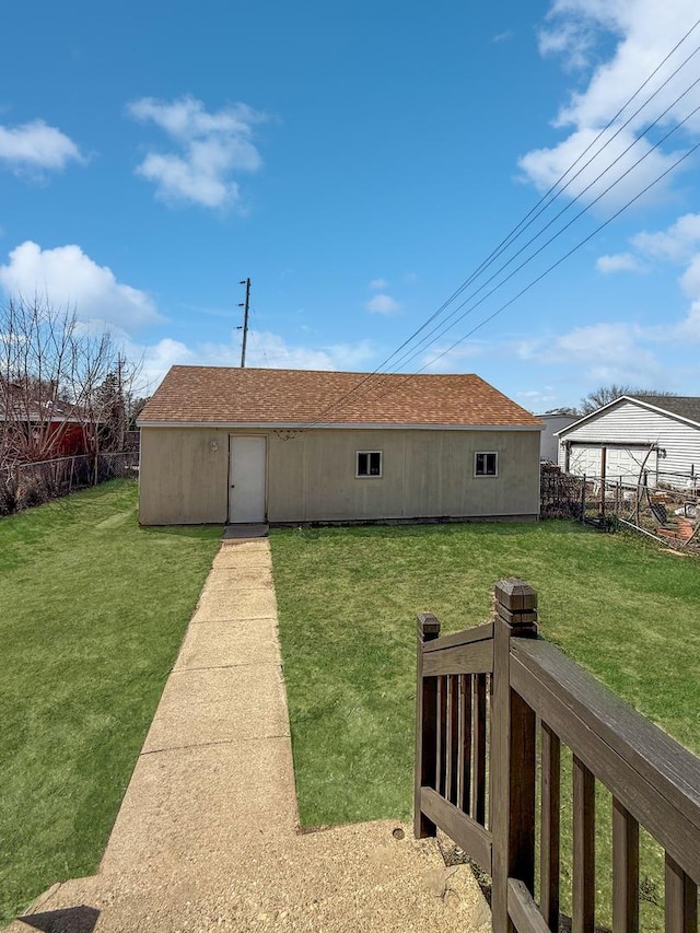 732 S 14th Ave, Freeport, IL 61032 - back of house featuring roof with shingles, a yard, and fence