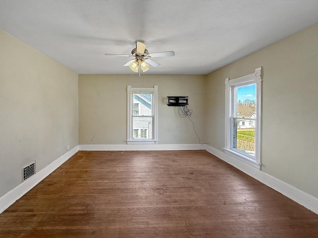 732 S 14th Ave, Freeport, IL 61032 - spare room featuring wood finished floors, ceiling fan, baseboards, and visible vents