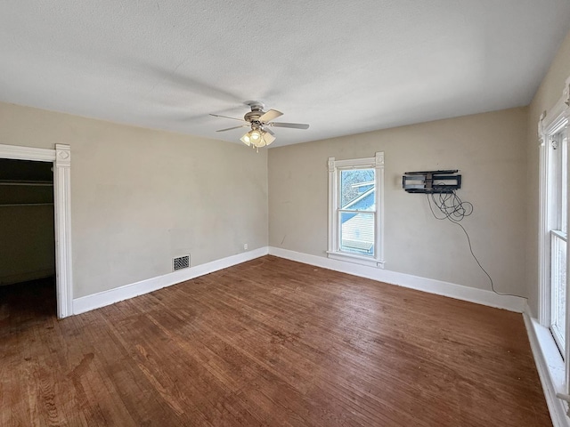 732 S 14th Ave, Freeport, IL 61032 - unfurnished bedroom with visible vents, baseboards, a ceiling fan, and wood finished floors