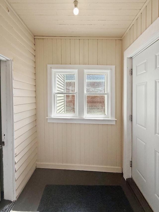 732 S 14th Ave, Freeport, IL 61032 - spare room featuring wooden walls, baseboards, and wood ceiling