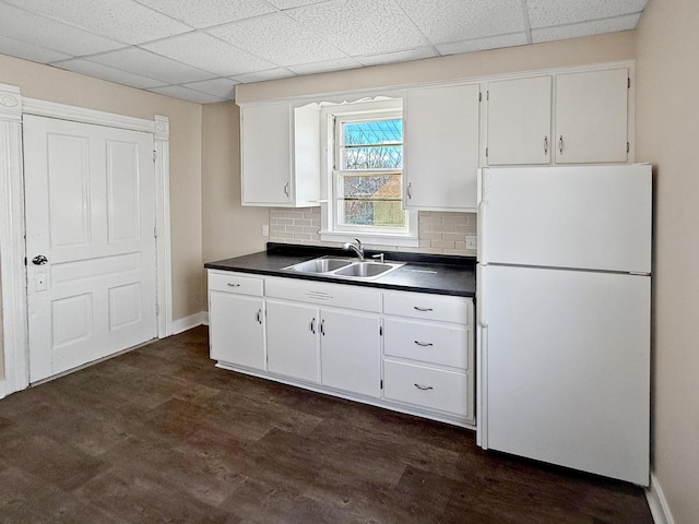 732 S 14th Ave, Freeport, IL 61032 - kitchen with a sink, freestanding refrigerator, white cabinetry, and dark countertops