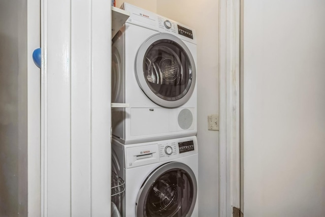 washroom with stacked washing machine and dryer