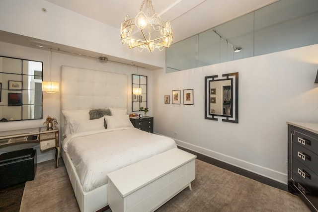 bedroom with a chandelier, baseboards, and lofted ceiling