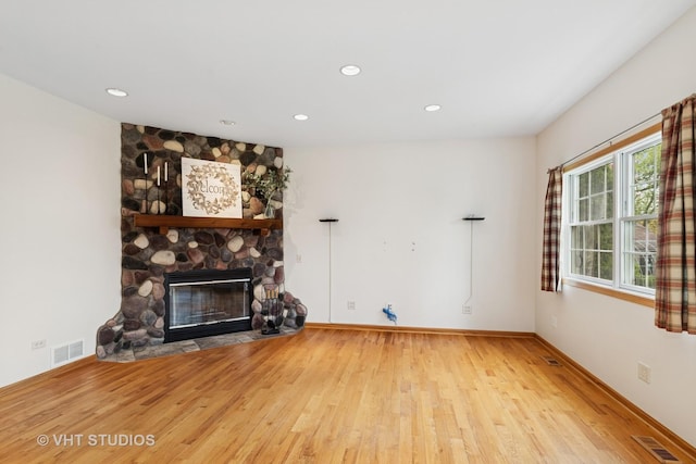 3625 Johns Manville Ave, Gurnee, IL 60031 - unfurnished living room featuring recessed lighting, visible vents, a stone fireplace, and wood finished floors