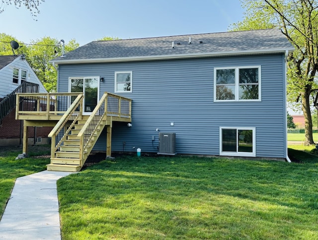 back of property featuring a wooden deck, stairs, a yard, central AC, and a shingled roof