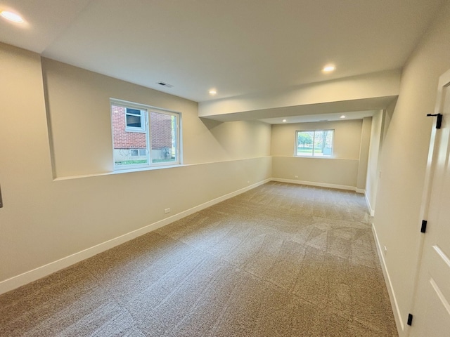 unfurnished room with light colored carpet, baseboards, and recessed lighting