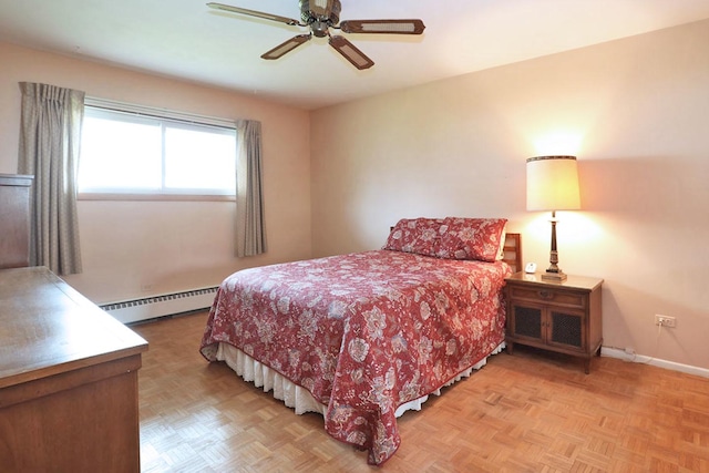 bedroom featuring ceiling fan, a baseboard heating unit, and baseboards